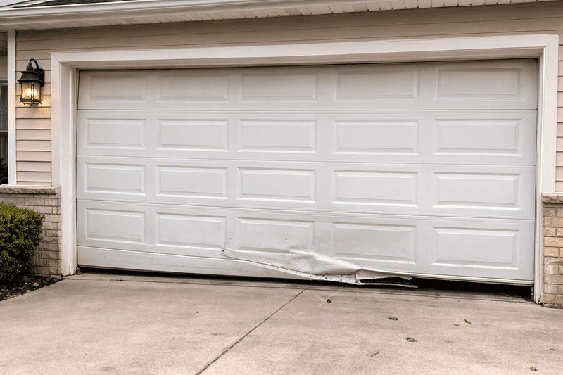 A broken garage door that needs replacement